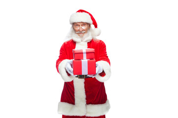 Christmas. Smiling Santa Claus in white gloves is holding two gift red boxes with a bow, one on the other. Isolated on white background.