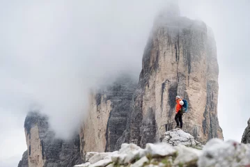 Foto op Aluminium Climber on the high rocks background. Sport and active life concept. Adventure and travel in the mountain region in the Dolomites, Italy. © biletskiyevgeniy.com