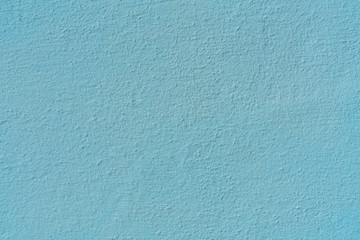 Plastered concrete wall, painted in blue, surface texture
