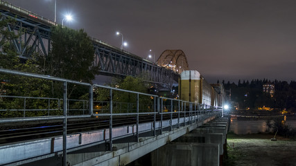 Patullo Bridge, Surrey, British Columbia, Canada. Long exposure of the bridge over the water. Sky Train Bridge.