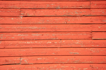 Aging boards on the side of an old red barn