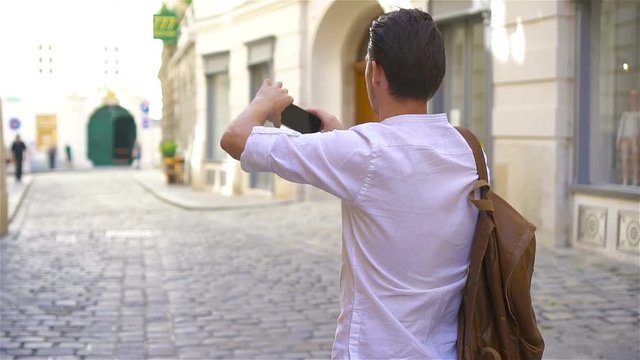 Young man background the old european city take selfie