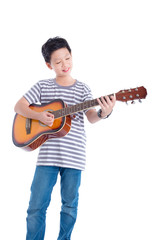 Young asian boy playing guitar and smiles over white background