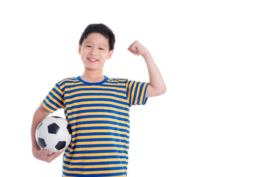 Young asian boy holding ball and smiles over white background