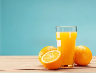 Orange juice and slices of orange on background