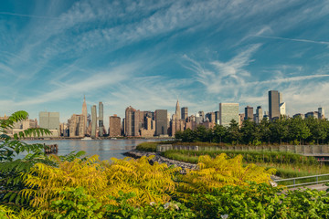 Naklejka premium Manhattan midtown skyline with lots of greens from Long Island City in early summer morning