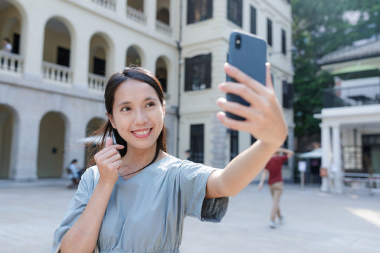 Woman taking selfie with cellphone