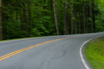 Fototapeta na wymiar Motion Blur Driving Around Country Road