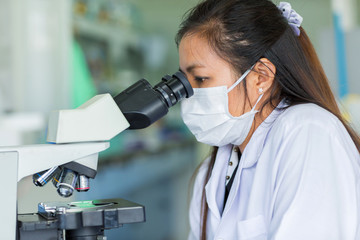 Scientist using a microscope in a laboratory, concept science and technology