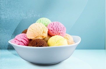 Ice cream scoops in bowl on white background