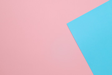 Blue and pink pastel papers geometric lay as background.