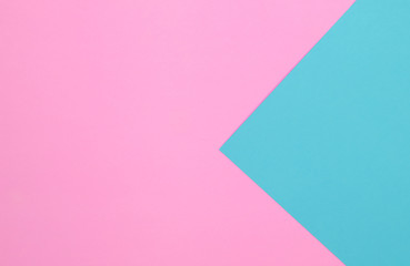 Pink and blue pastel papers geometric lay as background.