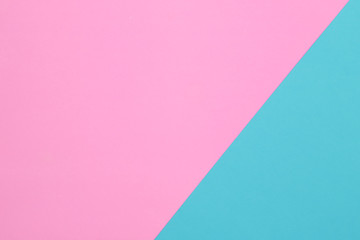 Pink and blue pastel papers geometric lay as background.
