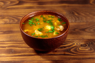 Kharcho soup with meat and rice on wooden table