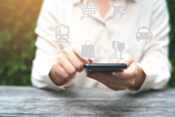Smart phone application, transportation, booking, shopping, eating concept. Woman use smart phone on background.