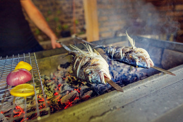 grilled fish food. grill from a dorado. dorado on skewers. aurata fish