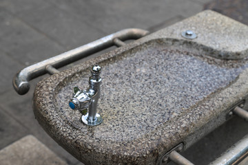 Closeup of drinking water fountain in public park.