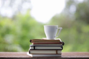 White cup and notebook at outdoor