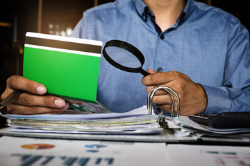 Businessman hands holding saving account passbook and auditing, Account and Saving concept.