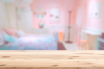 Wood foreground with blur pink lovely bedroom blur background for display products