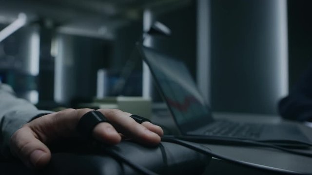 Close-up Shot of the Suspect's Hand Connected to the Lie Detector / Polygraph Test Machine, while Female Special Agent Conducts Questioning. 