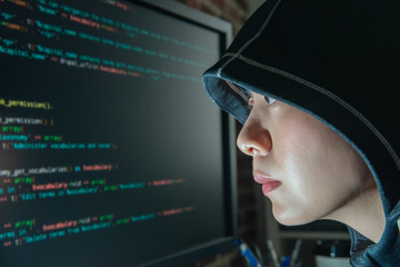 female hacker staring at the monitor seriously
