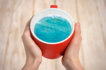 Ocean or sea in red cup. Creative idea