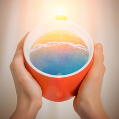 Red cup of coffee with the sea surf inside. Creative idea