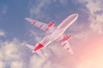 Flight of an airplane on a sunny day, bottom view