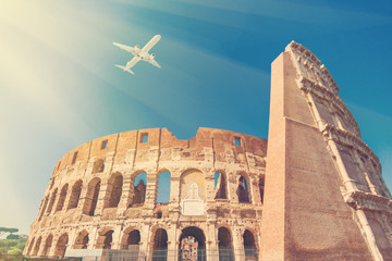 Airplane flying over Leaning Tower of Coliseum in Italy