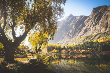 Autumn scene of morning in lower Kachura lake with mountains in the background and reflection in still water. Shangrila Skardu. Gilgit-Baltistan, Pakistan.