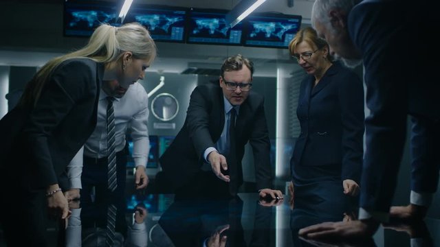 Diverse Team of Corporate Businesspeople Have Heated Discussion While Standing Around the Digital Touch Screen Table. Board of Directors of Import / Export Company Have Meeting.