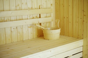 Obraz na płótnie Canvas wooden sauna bucket accessories interior of sauna spa
