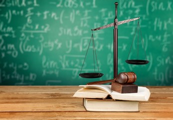 Justice Scales and books and wooden gavel on table. Justice