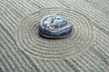 Fototapeta na wymiar Zen composition. Garden of stones.Calming patterns on the sand.
