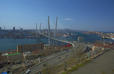 the bridge across the Bay, in the port city. sunny day and flourishing greenery