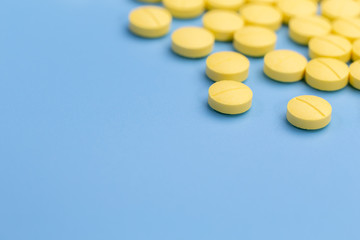 yellow pills on blue background