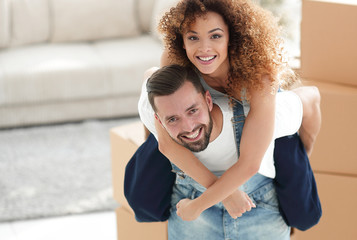 Portrait of a couple in love in a new empty apartment.