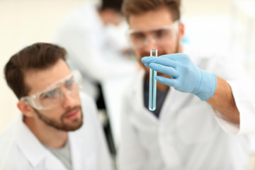 two scientists examining liquid in a test tube