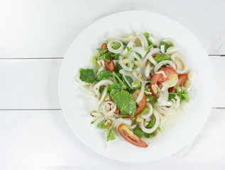 Green salad seafood eat healthy ,Onion and green  Salad in white Plate on wood floor background, Top view, with copy space for your text.