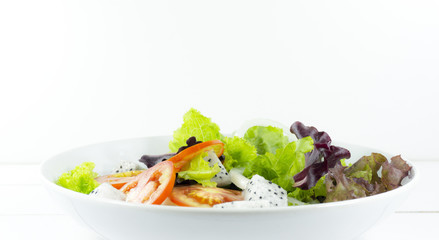 Fresh vegetable salad in white Plate on wood floor white background, measuring tape and fork, Close up, Copy space.