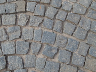 The road paved with gray cobblestone