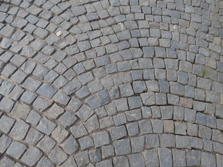 The road paved with gray cobblestone