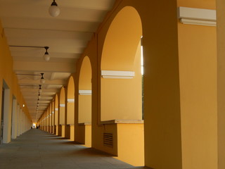 Long gallery with arches of yellow color, background