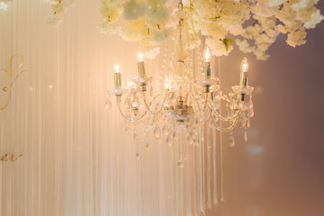 Floral elements of roof. Decorated chandelier on wedding