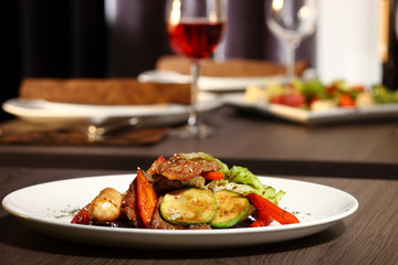 luxury dinner served on the table with glass of red wine