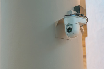 Modern CCTV camera on the wall concept or surveillance and monitoring