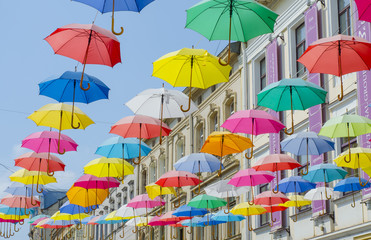 Fototapeta na wymiar Lviv city colorful iridescent umbrellas on the street.