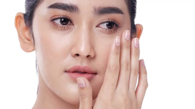 Asian beautiful woman touching her face at white background. People with beauty, makeup, health care concept.