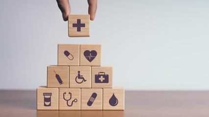 Concept of Insurance for your health, Hand hold wooden block with icon healthcare medical